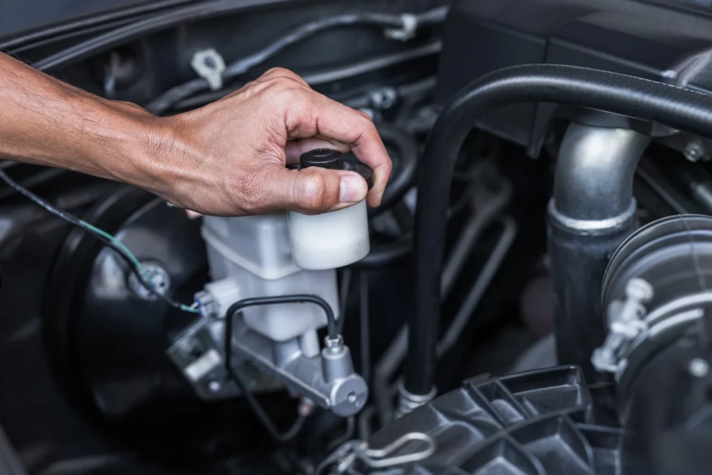 Brake fluid check being done during routine inspection